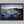 Ethereal Dawn coastal wall art featuring Northumbrian castle ruins, rocky shoreline and calm sea at sunrise