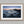 Ethereal Dawn coastal wall art featuring Northumbrian castle ruins, rocky shoreline and calm sea at sunrise