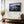 Ethereal Dawn coastal wall art featuring Northumbrian castle ruins, rocky shoreline and calm sea at sunrise