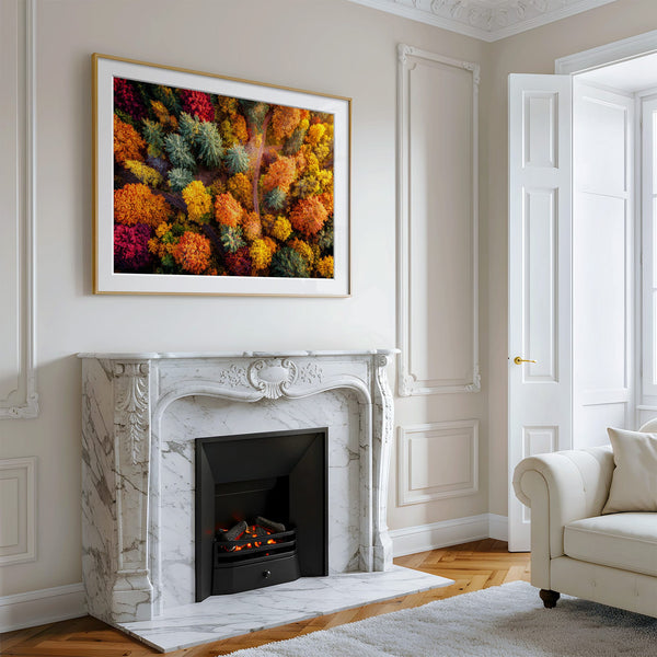 A large framed wall art print featuring a dense, colourful abstract floral or forest-like pattern in red, orange, yellow, green, and blue.