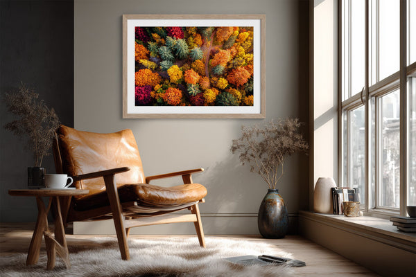 A large framed wall art print featuring a dense, colourful abstract floral or forest-like pattern in red, orange, yellow, green, and blue.
