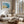 Abstract coastal artwork with layered blue waves, textured ivory forms and a warm golden shoreline.