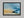 Abstract coastal artwork with layered blue waves, textured ivory forms and a warm golden shoreline.