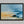 Abstract coastal artwork with layered blue waves, textured ivory forms and a warm golden shoreline.