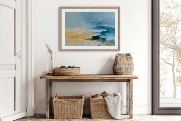 Abstract coastal artwork with layered blue waves, textured ivory forms and a warm golden shoreline.