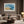 Abstract coastal artwork with layered blue waves, textured ivory forms and a warm golden shoreline.