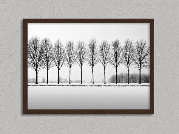 Black and white tree wall art featuring a row of bare winter trees across a minimalist snowy landscape