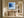 Black-framed blue abstract print above a rustic wooden bench in a bright hallway.