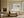 Pale blue coastal abstract in a light wood frame above a cream sofa and low wooden table.