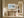 Pale blue coastal abstract in a light wood frame above a rustic wooden console table.