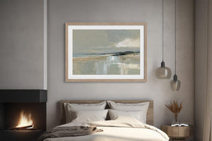 Pale Estuary print with a white mat and light wood frame above a bed near a fireplace.