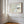 Close view of Pale Estuary in a slim wood frame with white mat on a sunlit paneled wall.
