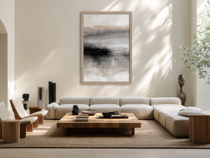 Framed grey, charcoal, beige, and white abstract artwork above a cream sectional sofa.