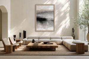 Framed grey, charcoal, beige, and white abstract artwork above a cream sectional sofa.