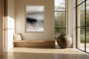 Framed grey abstract artwork above a built-in bench beside black-framed windows.