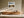White-framed mountain lake artwork hung above a floating wood sideboard.