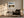 White-framed mountain lake artwork above an upholstered armchair, side table, and floor lamp.