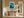 Framed blue glacial river artwork above a rustic wooden console table in a sunlit hallway.