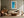 Framed turquoise shoreline artwork above a cream sofa, wooden coffee table, and leather lounge chair.