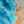 Aerial view of turquoise ocean waves meeting a warm sandy beach