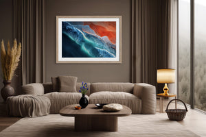 Ember Tide print in a light wood frame above a cream sofa, with a floor lamp nearby.