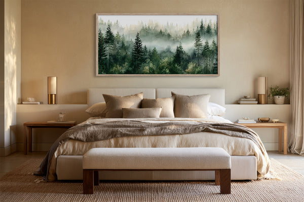 Large framed watercolor of layered pine trees above a beige bed with a bench.