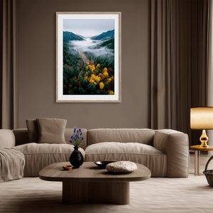Framed fine art print of a misty valley in fall colours. Red, gold, and evergreen forest hues captured in a vivid autumn woodland scene.
