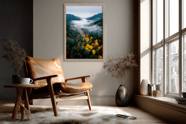 Framed fine art print of a misty valley in fall colours. Red, gold, and evergreen forest hues captured in a vivid autumn woodland scene.