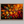 Canvas wall art of an autumn forest from above in crimson, gold, and flame hues. A vibrant seasonal landscape print. Ready to hang.