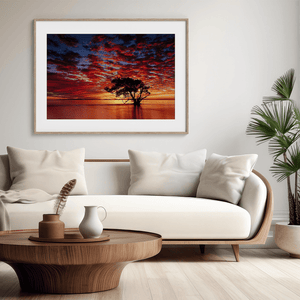 Framed wall art of a solitary ocean tree at sunrise. A serene fine art print capturing dawn’s quiet light over sea and sky.