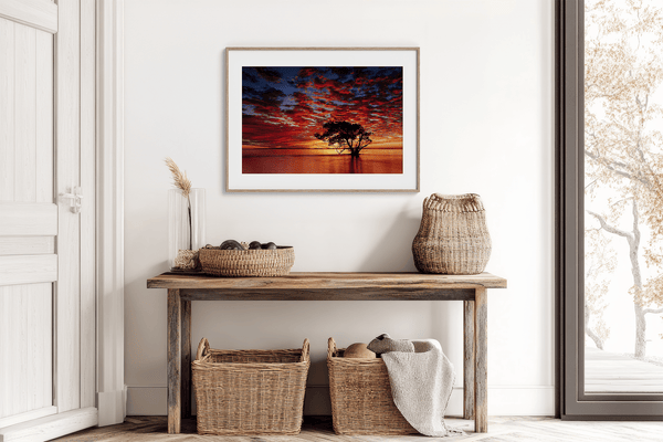 Framed wall art of a solitary ocean tree at sunrise. A serene fine art print capturing dawn’s quiet light over sea and sky.