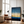 Framed wall art of an abstract seascape in deep indigo, blue, and gold. A minimalist horizon print evoking calm and renewal.