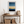 Framed wall art of an abstract seascape in deep indigo, blue, and gold. A minimalist horizon print evoking calm and renewal.