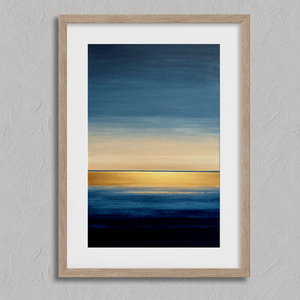 Framed wall art of an abstract seascape in deep indigo, blue, and gold. A minimalist horizon print evoking calm and renewal.