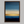 Framed wall art of an abstract seascape in deep indigo, blue, and gold. A minimalist horizon print evoking calm and renewal.