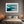 Framed wall art of abstract ocean waves in deep indigo, teal, and white. A calming coastal piece that’s ready to hang.