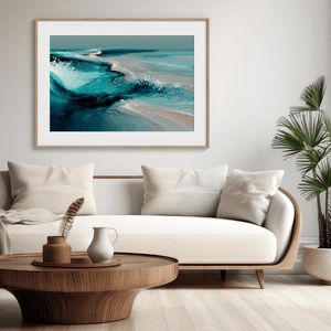 Framed wall art of abstract ocean waves in deep indigo, teal, and white. A calming coastal piece that’s ready to hang.