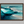 Framed wall art of abstract ocean waves in deep indigo, teal, and white. A calming coastal piece that’s ready to hang.