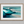 Framed wall art of abstract ocean waves in deep indigo, teal, and white. A calming coastal piece that’s ready to hang.