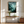 Framed wall art of a mystical mountain scene in emerald and teal hues. A tranquil, enchanting landscape print. Ready to hang.