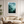 Framed wall art of a mystical mountain scene in emerald and teal hues. A tranquil, enchanting landscape print. Ready to hang.