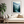 Framed wall art of a misty woodland with tall pines and a winding river. Soft greens and blues to bring calm to your home.