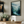Framed wall art of a misty woodland with tall pines and a winding river. Soft greens and blues to bring calm to your home.
