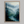 Framed wall art of a misty woodland with tall pines and a winding river. Soft greens and blues to bring calm to your home.