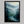 Framed wall art of a misty woodland with tall pines and a winding river. Soft greens and blues to bring calm to your home.