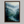 Framed wall art of a misty woodland with tall pines and a winding river. Soft greens and blues to bring calm to your home.