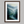 Framed wall art of a misty woodland with tall pines and a winding river. Soft greens and blues to bring calm to your home.