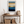Framed wall art of an ocean sunset in coral, peach, and blue tones. A timeless abstract seascape print. Ready to hang.
