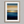 Framed wall art of an ocean sunset in coral, peach, and blue tones. A timeless abstract seascape print. Ready to hang.