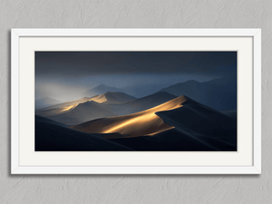 Light Across the Dunes – Desert Landscape Wall Art Print in a white frame with a mount